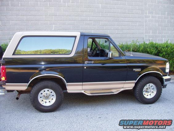 Side view of a 1996 Ford Bronco with a tan top and tan lower trim