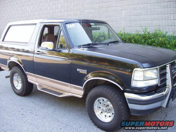 1996 Ford Bronco, dark blue and tan, 3/4 front view, with chrome trim and running boards