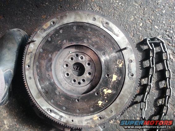 Clutch flywheel with a boot and chain nearby