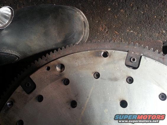 Close-up of a car's flywheel with a boot in the upper left corner