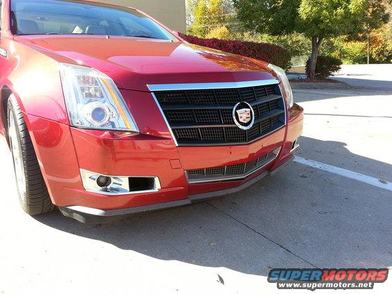 Front view of a red 2008 Cadillac CTS. The grille has a chrome surround and black mesh