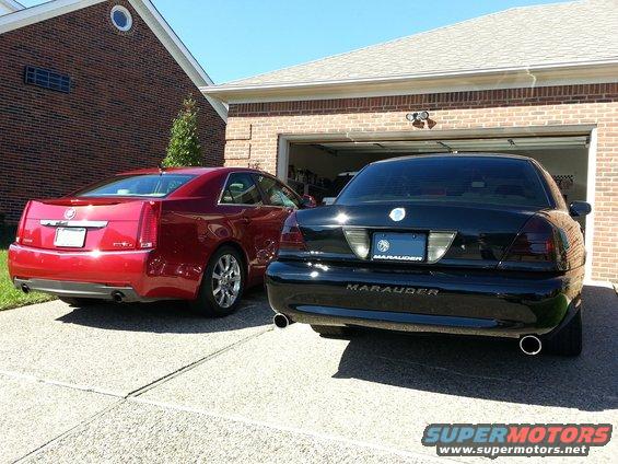 Red 2008 Cadillac CTS and black Mercury Marauder parked in driveway