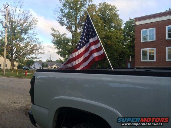 White 2006 Chevrolet Silverado 2500 rear quarter panel with American flag