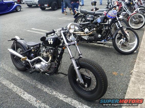 Black custom motorcycle with '44' emblem on fuel tank, front view