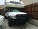 1997 Dodge 3500 - White 1997 Dodge 3500 truck fitted with a Lance camper shell and a heavy-duty brush guard.