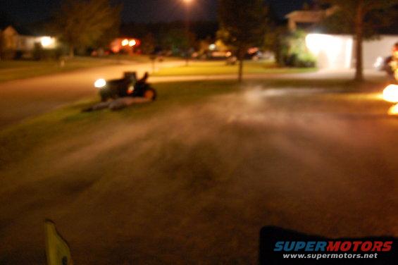 ATV on its side in a grassy area at night