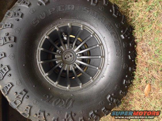 Tire with "SUPER SWAMPER IROK" text and a multi-spoke wheel