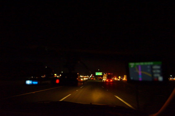 GPS display showing route on a highway at night