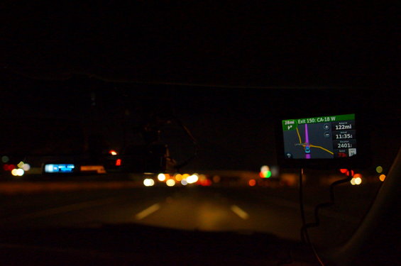 Interior view at night, GPS screen shows Exit 150: CA-18 W, 122mi remaining