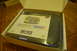 2003 Ford Taurus - A radar detector is shown inside its packaging, with the product name clearly visible.