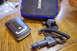 2003 Ford Taurus - A radar detector, its charger, and mount are laid out on a table.