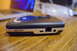 2003 Ford Taurus - An Escort radar detector sits on a wooden surface, with a laptop blurred in the background.