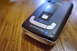 2003 Ford Taurus - Close-up of a black Passport Max radar detector with silver trim, resting on a wooden surface.