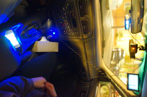 Car interior with blue lights, tissue box, and phone mount