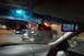 2003 Ford Taurus - View from inside a car at night, with various electronic devices mounted on the dashboard and windshield.