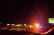 2003 Ford Taurus - View from inside a vehicle on a highway at night, with flashing emergency lights visible in the distance.