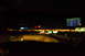 2003 Ford Taurus - View from inside a car at night, showing the dashboard with navigation and a radar detector, with city lights blurred in the background.