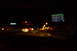 2003 Ford Taurus - View from inside a vehicle at night, with a GPS screen displaying navigation.