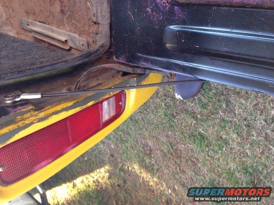 1979 Ford Bronco tailgate interior with cable and taillight visible