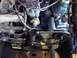 1979 Ford Bronco - Close-up view of the engine compartment, focusing on the power steering system and associated components.