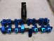 1971 Ford Ranchero - Blue aluminum roller rocker arms and associated hardware laid out on a white surface.