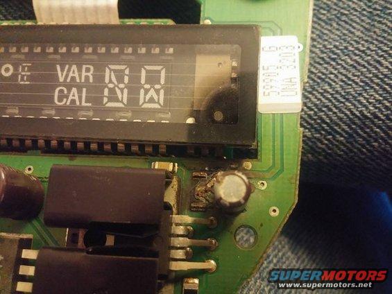 Close-up of a digital display showing 'VAR' and 'CAL' with numbers, on a green circuit board