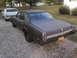 1966 Oldsmobile Cutlass - Two Oldsmobile sedans, a 1967 Delta 88 and a 1966 Cutlass, are parked on a gravel driveway.