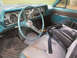 1966 Oldsmobile Cutlass - The interior of a classic car, a turquoise dashboard and worn seats.