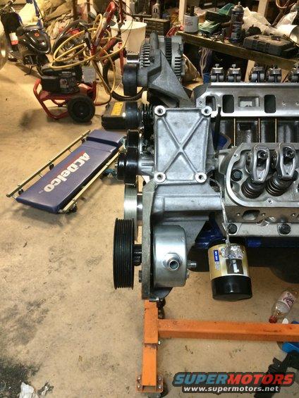 Ford V8 engine on an orange stand, with an ACDelco creeper nearby
