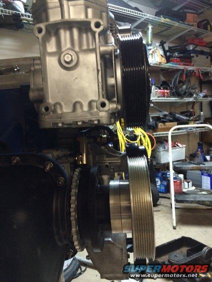 supercharger assembly with multiple pulleys and yellow wiring