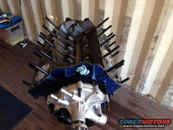 Engine block with water pump installed, showing intake manifold bolts