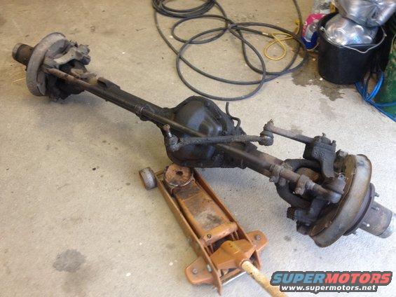 Front axle assembly with drum brakes and steering linkage on a floor jack