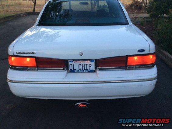 White Ford Crown Victoria rear view, California license plate 'OL CHIP', aftermarket Ford exhaust tip