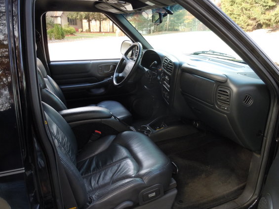 Black leather seats and dashboard of an SUV interior