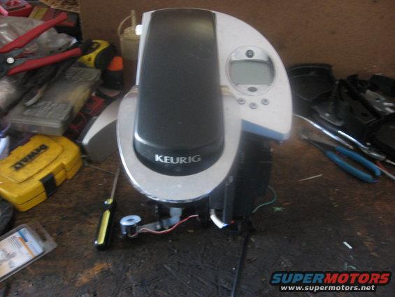 Keurig coffee maker on a workbench with tools