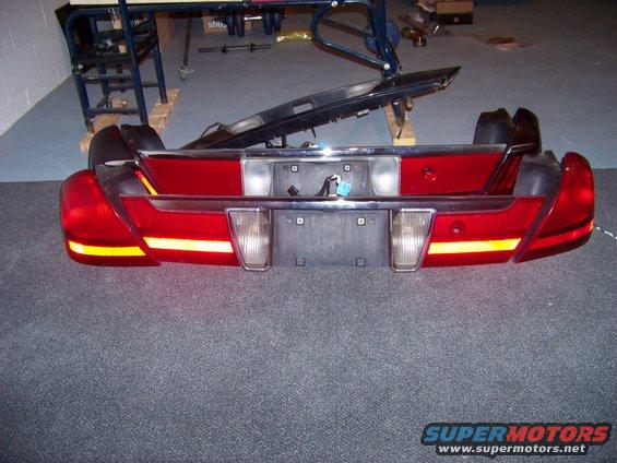 Car tail lights and bumper assembly with chrome trim and license plate holder