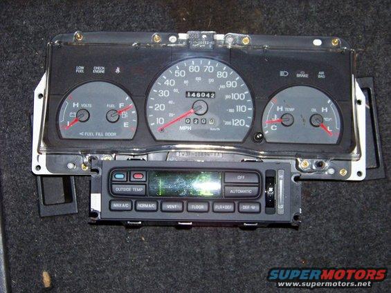 Car dashboard cluster with speedometer, fuel gauge, temp gauge, and climate controls
