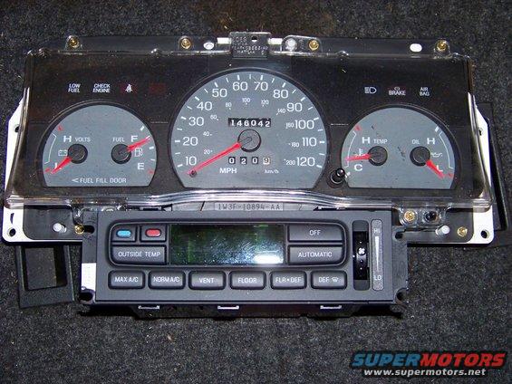 Car dashboard instrument cluster with odometer reading 146042, and climate control unit