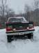 1990 Ford Bronco - A 1990 Ford Bronco sits in the snow, its front grille visible.