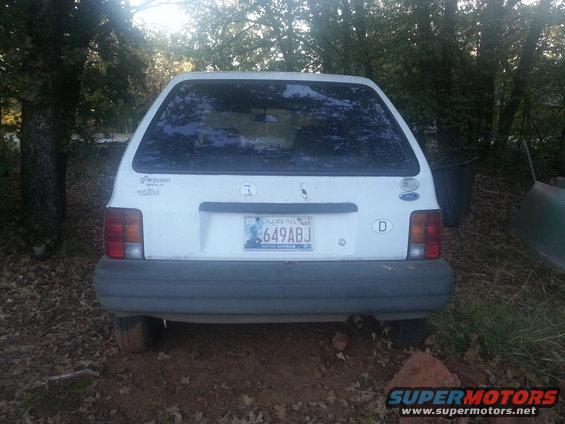 Rear view of a white 1991 Ford Festiva parked outside