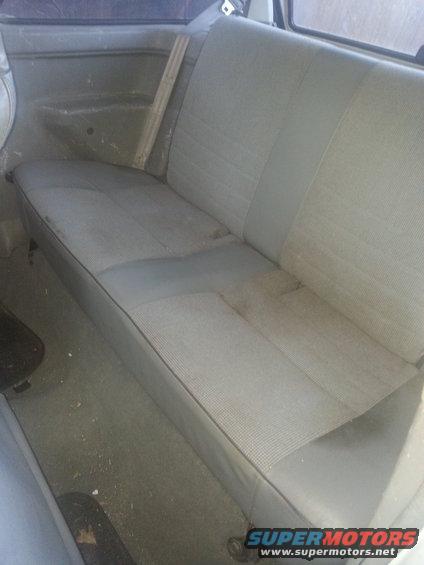 Gray fabric rear seat interior with a wooden support