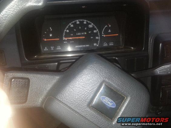 Dashboard view of a car with a Ford logo on the steering wheel and a speedometer showing 140197 miles