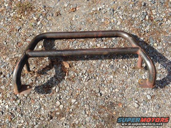 rusted bull bar on gravel ground