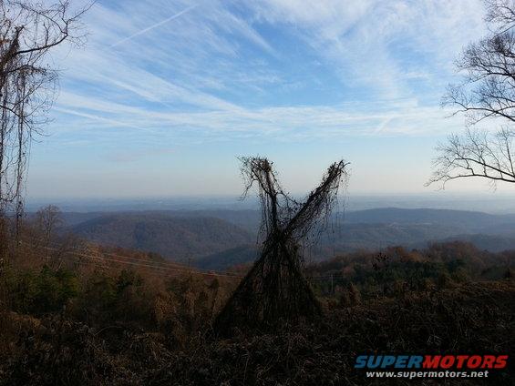 Overgrown structure in a landscape with a Supermotors.net watermark