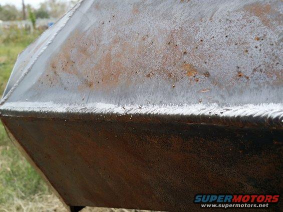 Close-up of a rusty, angular metal object with visible weld lines