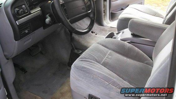 Interior shot of a 1995 Ford Bronco showing the driver's side dashboard, steering wheel, and front seats