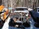 1974 Dodge Challenger - A derelict muscle car sits in a snowy junkyard, its front end heavily rusted and exposed.