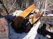 1974 Dodge Challenger - Junkyard scene with a damaged orange car hood and door visible amongst other derelict vehicles in the snow.