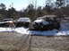 1974 Dodge Challenger - Several old cars, including a 1974 Dodge Challenger, sit in a snowy junkyard scene.