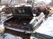 1974 Dodge Challenger - A derelict 1974 Dodge Challenger sits in a junkyard, its trunk open and filled with debris.